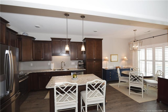 kitchen featuring dark wood-style floors, electric range, a sink, dark brown cabinetry, and stainless steel fridge