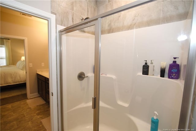 full bath featuring a stall shower, visible vents, and connected bathroom