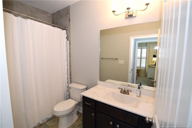 bathroom with toilet, curtained shower, and vanity