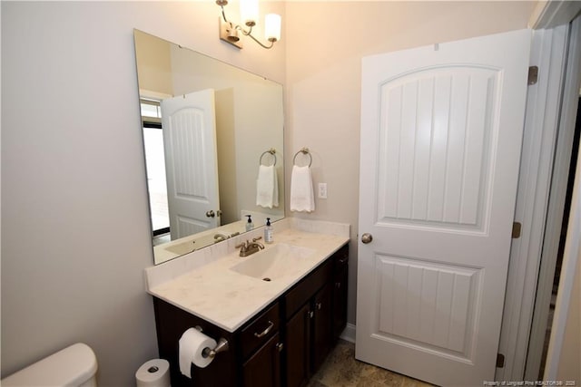 bathroom with toilet and vanity