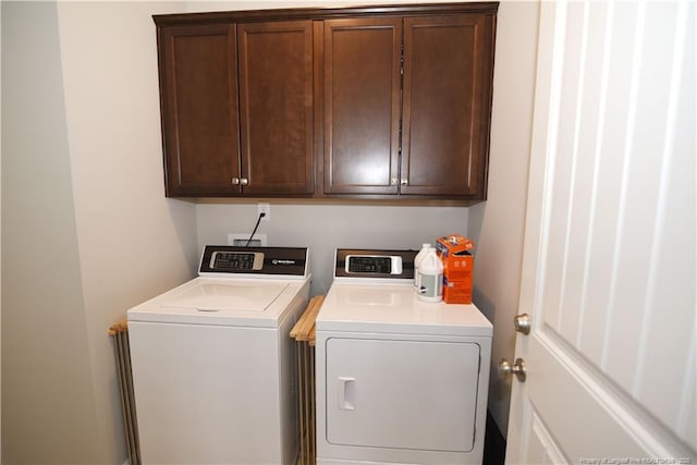 laundry room featuring washer and dryer and cabinet space