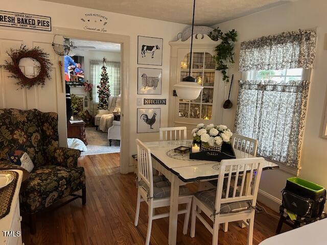 dining room with a ceiling fan and wood finished floors