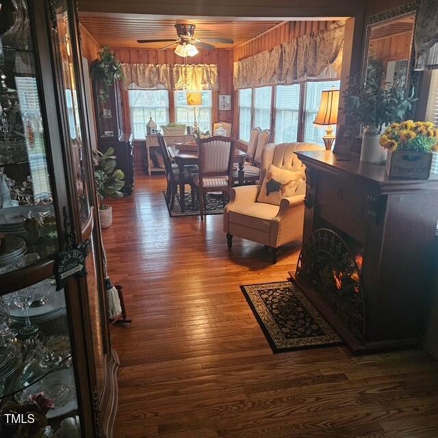 living room with ceiling fan and wood finished floors