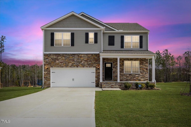 view of front of property with an attached garage, covered porch, stone siding, driveway, and a lawn