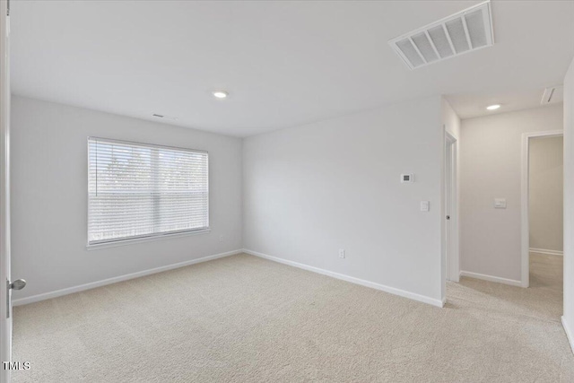 carpeted spare room with recessed lighting, visible vents, and baseboards