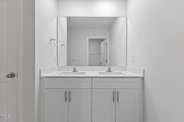 bathroom featuring a sink and double vanity