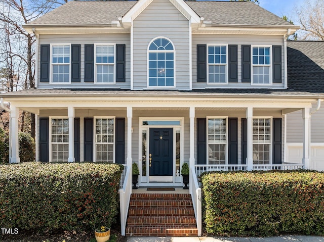 view of front facade featuring a porch and a shingled roof