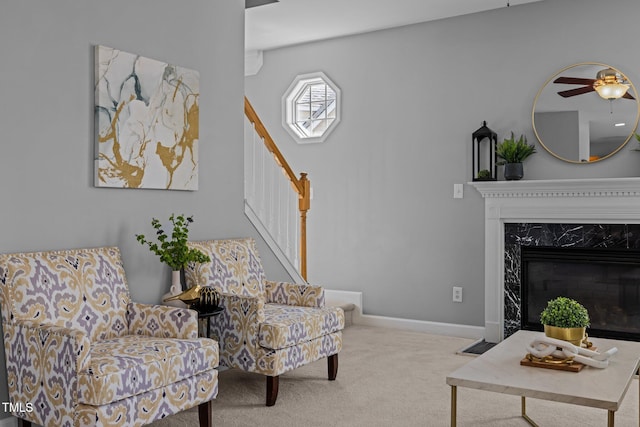 carpeted living room featuring stairs, a fireplace, and baseboards