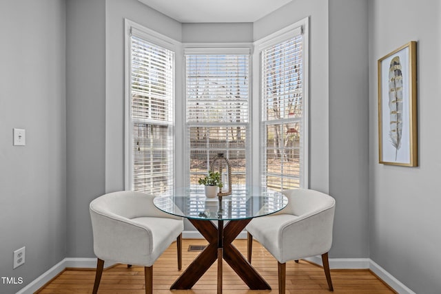 dining room featuring baseboards and light wood finished floors