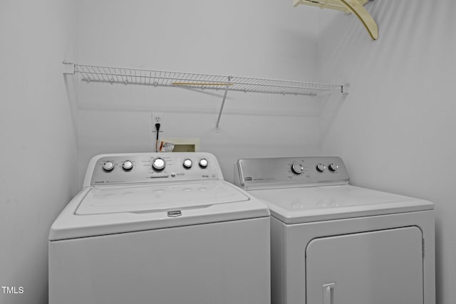 clothes washing area with laundry area and washing machine and clothes dryer