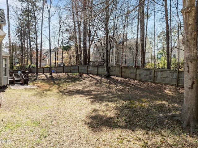 view of yard with a deck and a fenced backyard