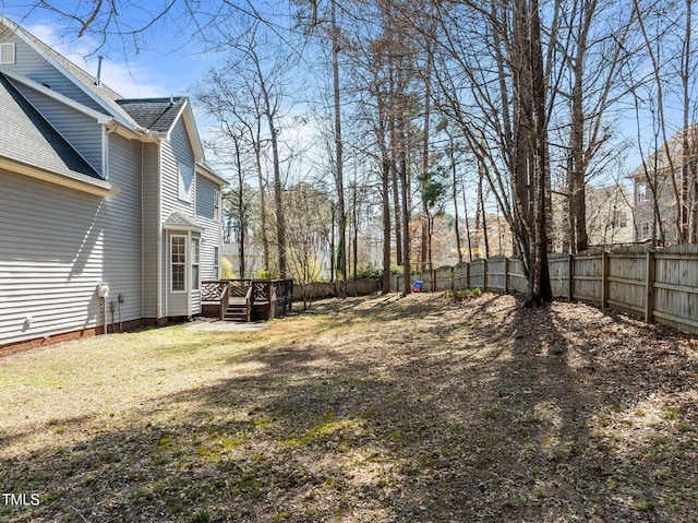 view of yard featuring a deck and fence