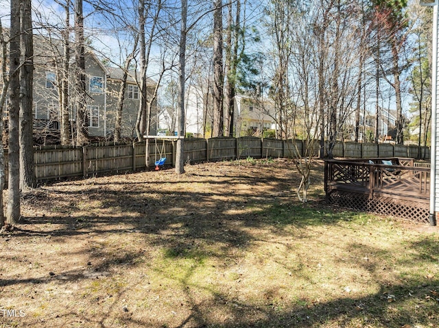 view of yard featuring a deck and a fenced backyard