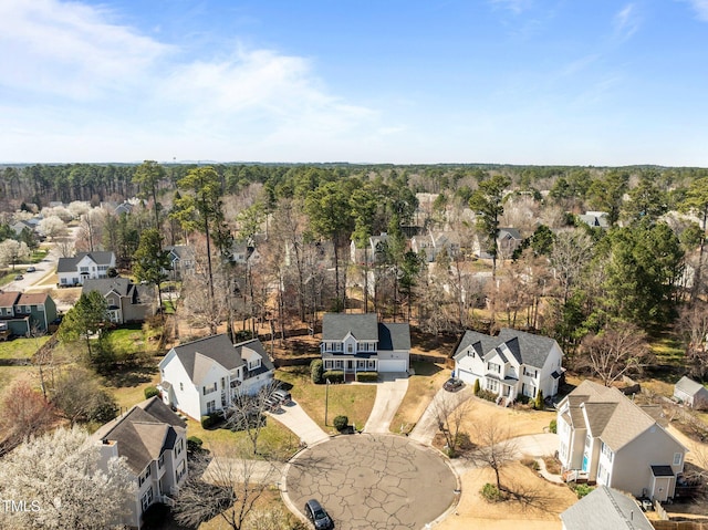 birds eye view of property with a residential view and a wooded view