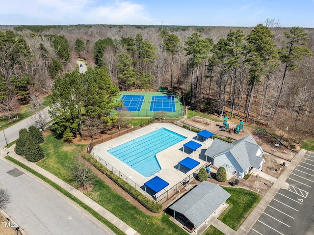 birds eye view of property featuring a view of trees