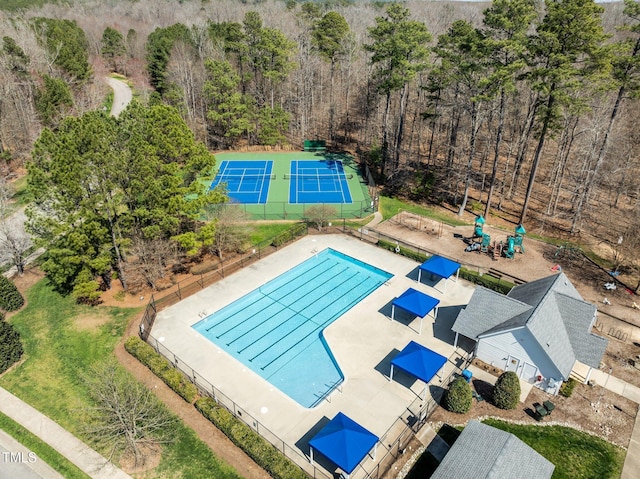 pool with a tennis court and fence