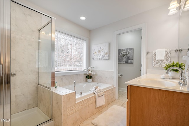 full bathroom featuring a bath, a stall shower, and vanity