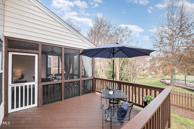 wooden deck with a sunroom