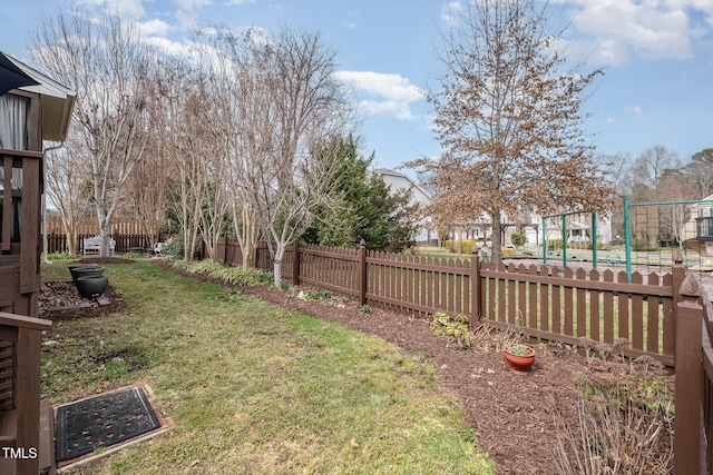 view of yard with a playground and fence