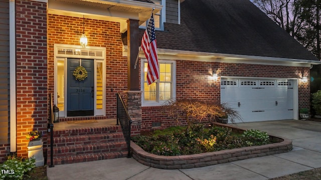 entrance to property featuring an attached garage, a shingled roof, concrete driveway, crawl space, and brick siding