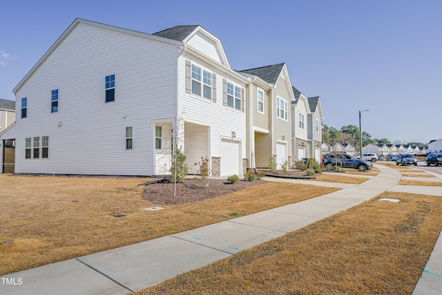 view of home's exterior featuring a residential view and a lawn