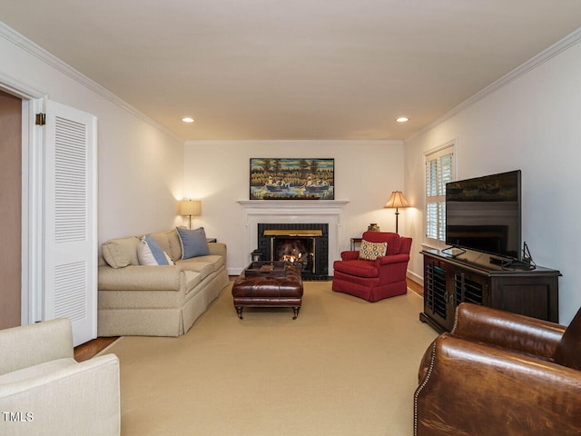 carpeted living area with crown molding, recessed lighting, and a lit fireplace