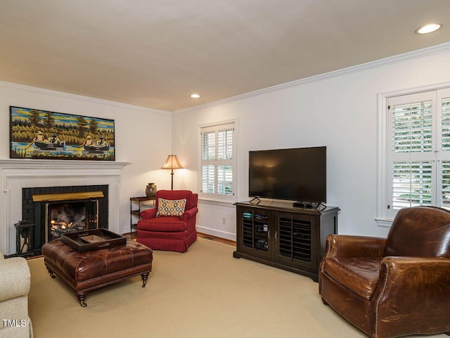 carpeted living room featuring a wealth of natural light, a glass covered fireplace, recessed lighting, and ornamental molding