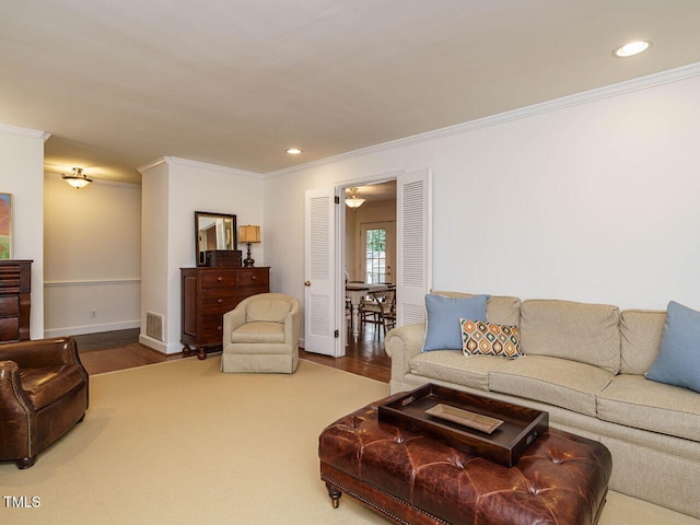 living room with wood finished floors, recessed lighting, visible vents, and ornamental molding