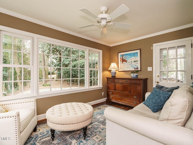 living room featuring baseboards, plenty of natural light, wood finished floors, and crown molding