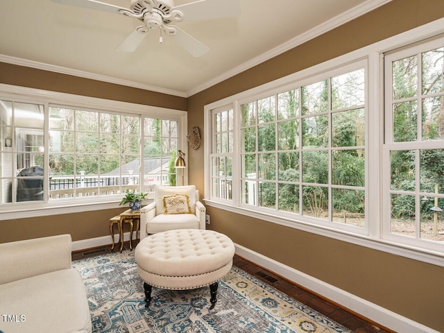 sunroom featuring ceiling fan