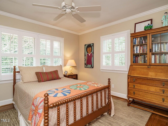 bedroom with multiple windows, wood finished floors, baseboards, and ornamental molding