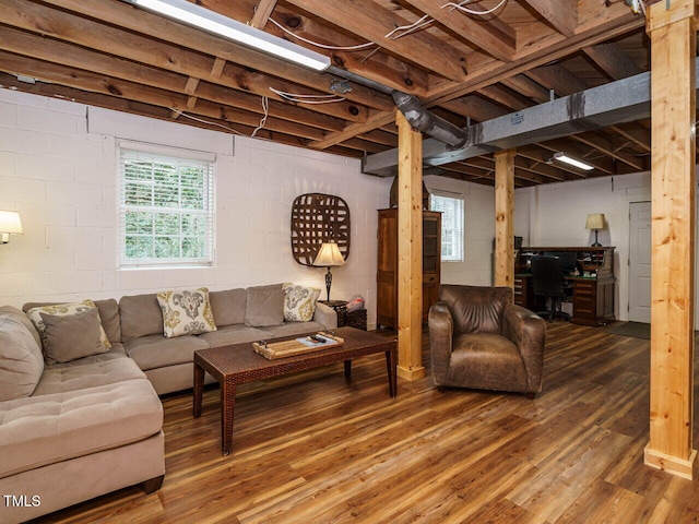 living room featuring concrete block wall and wood finished floors