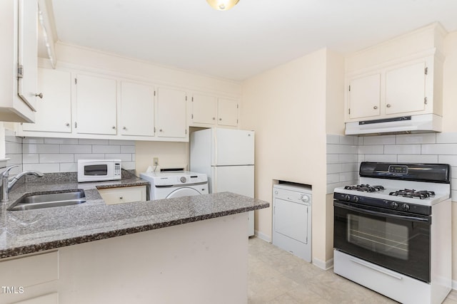 kitchen with under cabinet range hood, white appliances, washer / dryer, and a sink