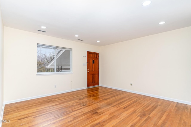 spare room featuring baseboards, recessed lighting, visible vents, and light wood-type flooring