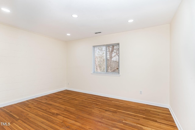 unfurnished room featuring recessed lighting, visible vents, baseboards, and wood finished floors