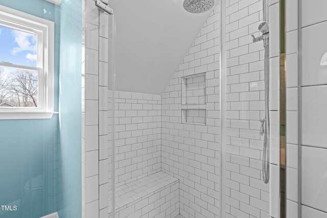 full bath featuring lofted ceiling and a stall shower