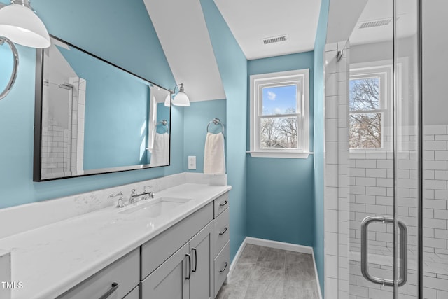 bathroom featuring visible vents, baseboards, vanity, and a shower stall