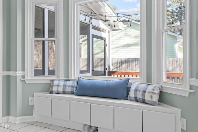 sitting room featuring light tile patterned floors, visible vents, and baseboards