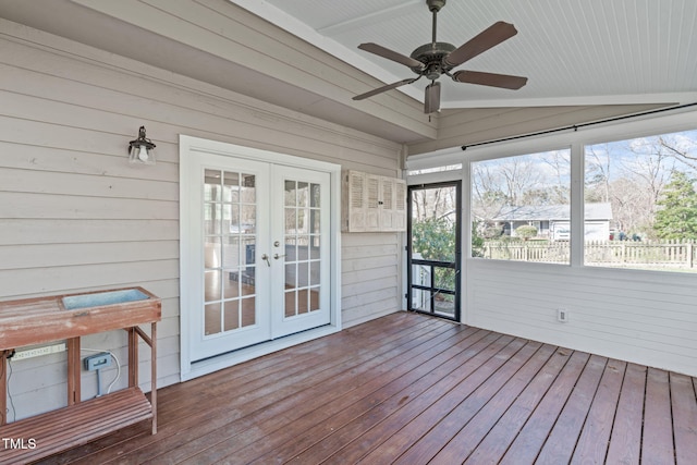 unfurnished sunroom featuring a ceiling fan, vaulted ceiling, and french doors