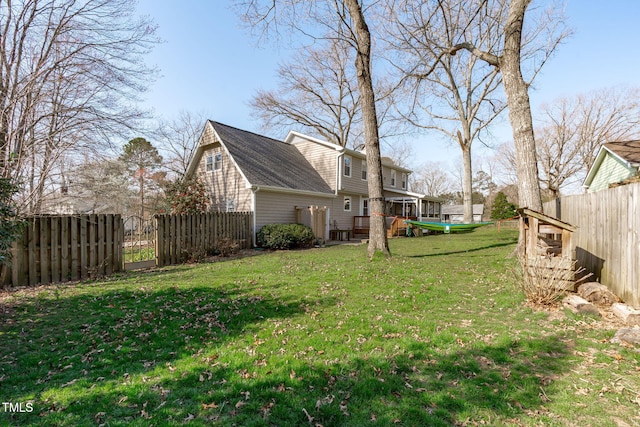 view of yard with a deck and fence