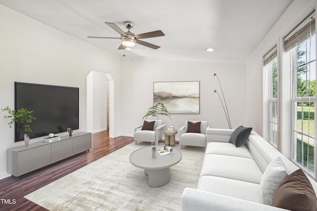 living room with baseboards, arched walkways, a ceiling fan, wood finished floors, and recessed lighting