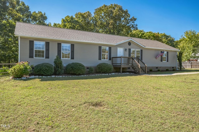 view of front of house featuring crawl space, roof with shingles, fence, and a front yard