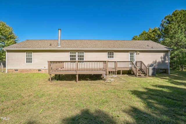 rear view of house with crawl space, a lawn, and a wooden deck