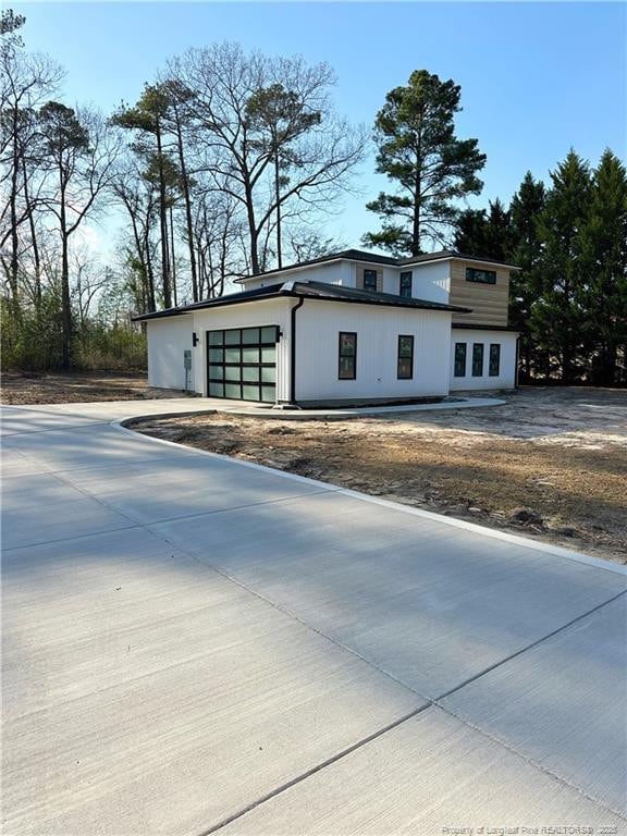 exterior space with a garage and concrete driveway