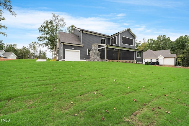 view of front of home featuring an attached garage, a front yard, and a sunroom