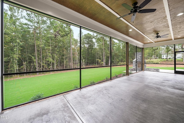 unfurnished sunroom featuring wooden ceiling and a ceiling fan