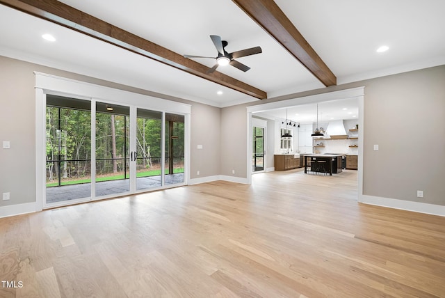 unfurnished living room with beam ceiling, recessed lighting, light wood-style floors, and baseboards