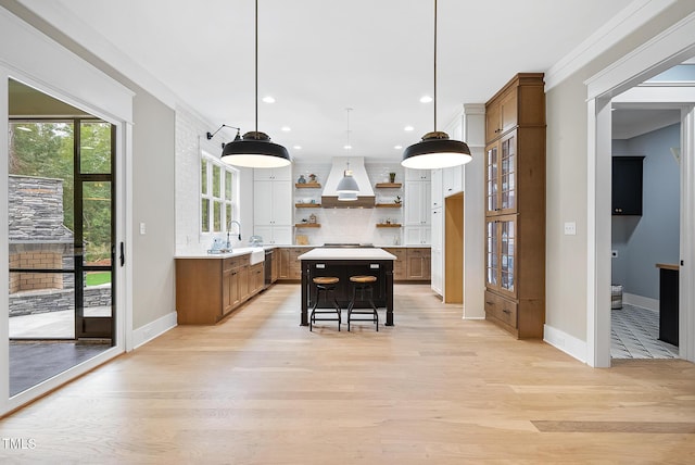 kitchen with custom exhaust hood, brown cabinets, open shelves, and a kitchen island