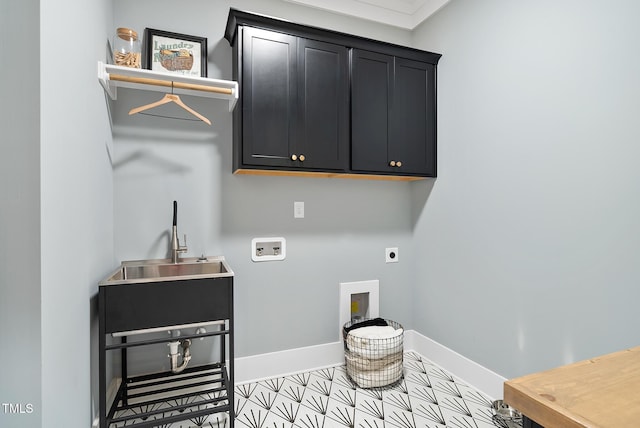 laundry room with hookup for a washing machine, baseboards, cabinet space, a sink, and electric dryer hookup