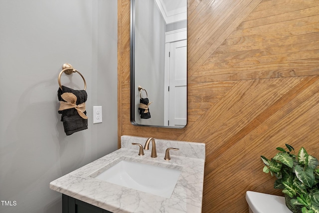 half bathroom with vanity and toilet